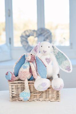 2 knitted rabbits in variegated yarn.