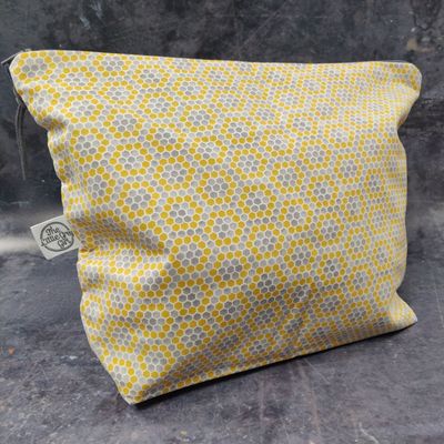 A yellow and grey hexagon print project bag.