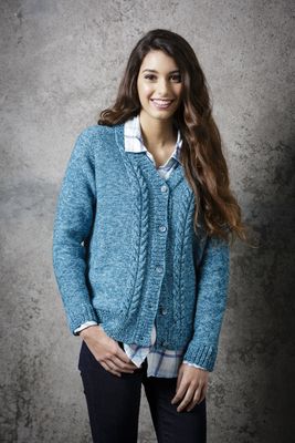 A woman is wearing a bright blue knitted cardigan with cable detail down the front.