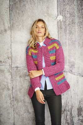 A woman is wearing a dark pink knitted cardigan with a few green and blue stripes.
