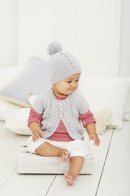 A baby is wearing a grey cable knit cardigan and a matching hat.