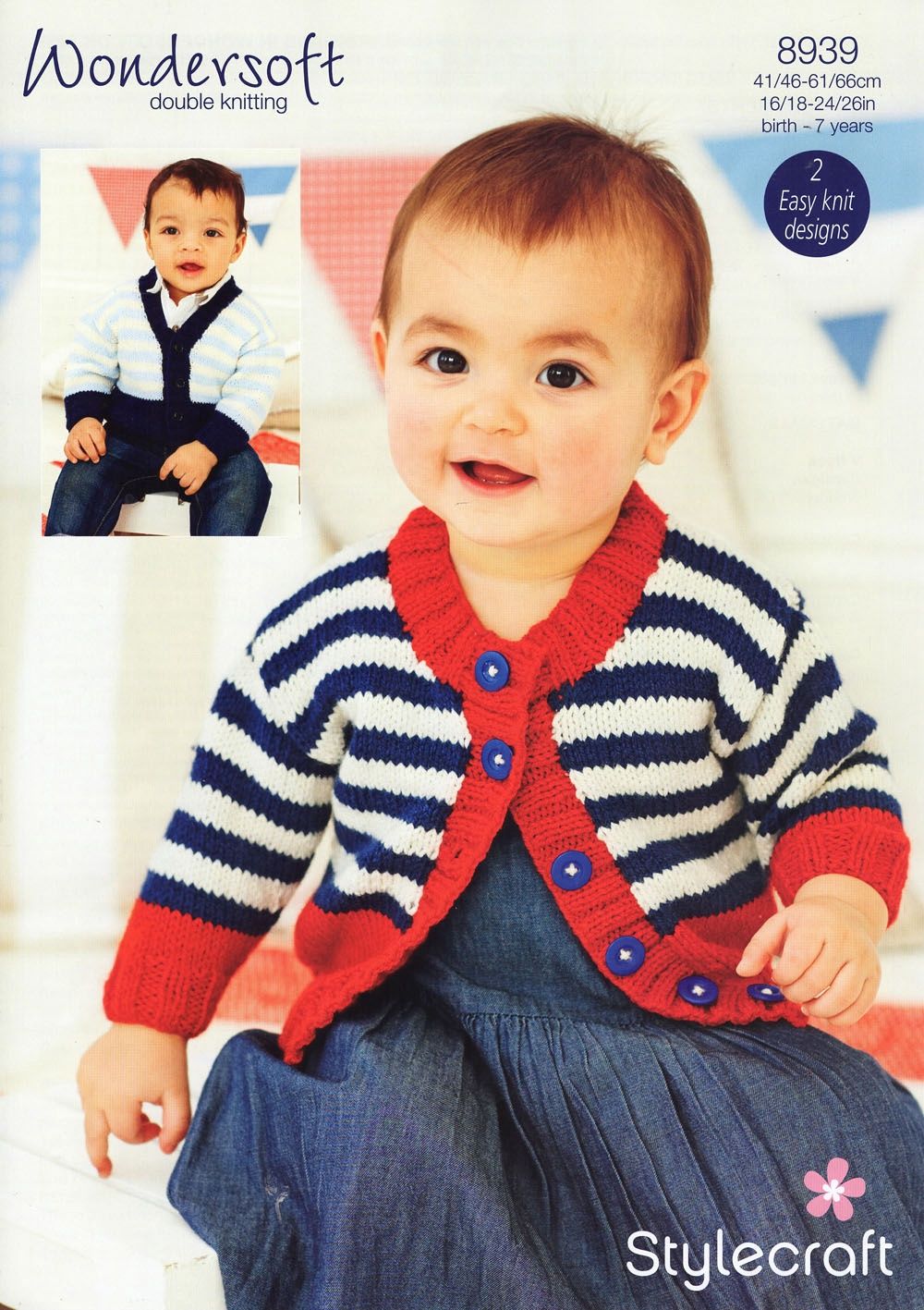 A baby is wearing a stripy knitted cardigan in navy blue and cream with red edging.