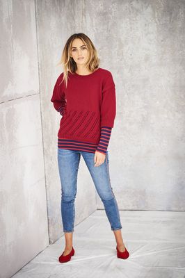 A woman is wearing a red knitted sweater.