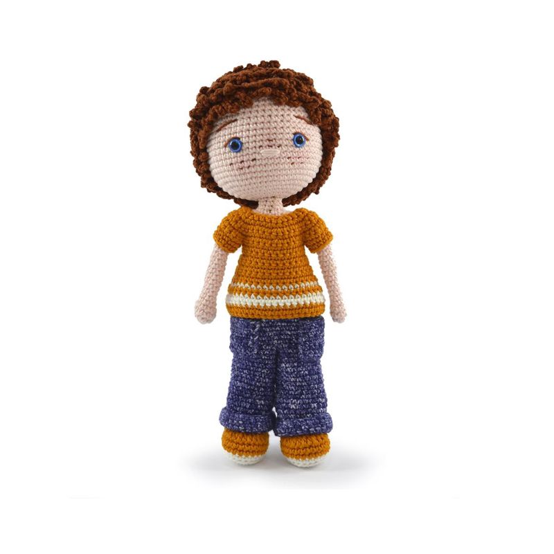 A crocheted doll, of a white boy with brown hair, an orange t-shirt, blue jeans and orange shoes.