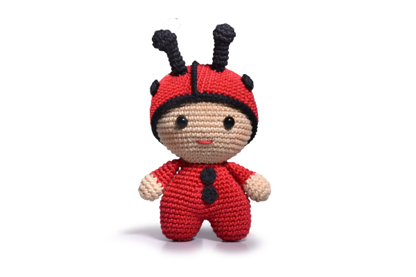 A red and black crocheted ladybug toy.