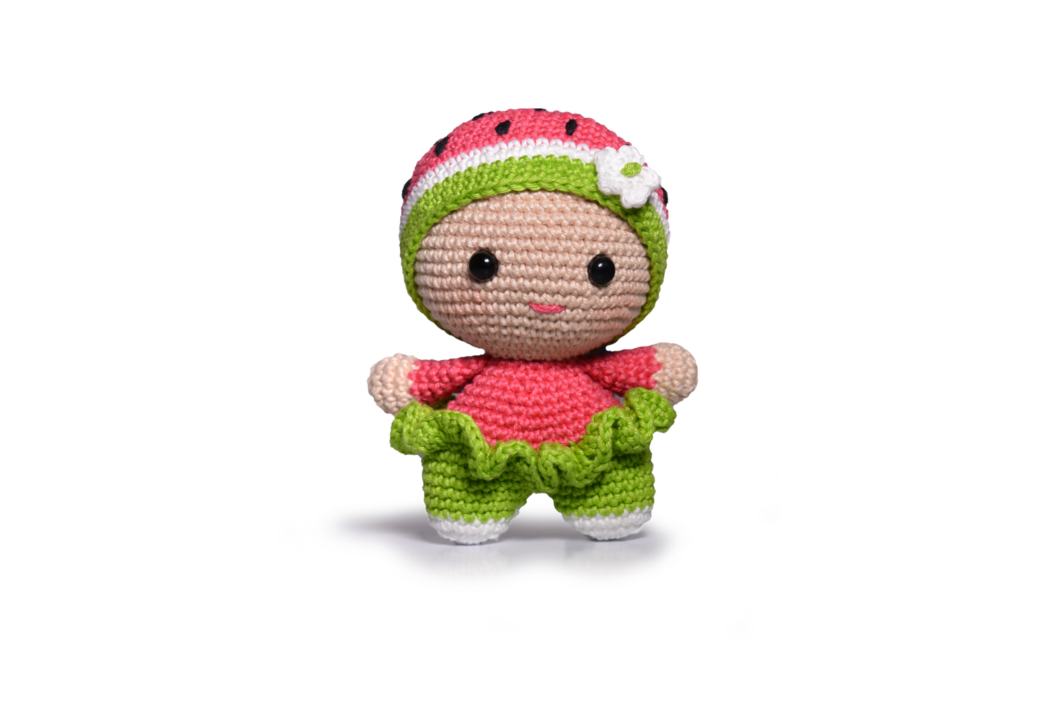 A green and red crocheted watermelon doll toy.