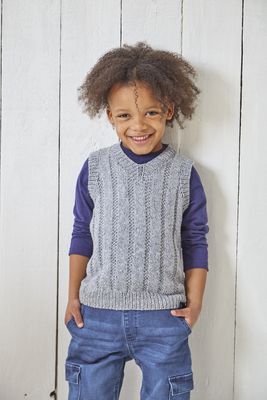 A boy is wearing a blue-grey knitted tank top.