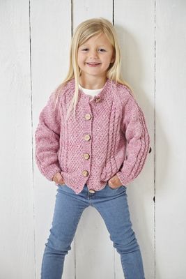 A girl is wearing a pink knitted cardigan.