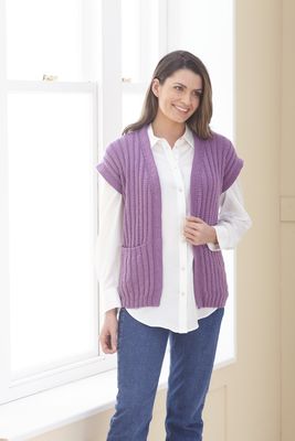 A woman is wearing a purple knitted sleeveless jacket.