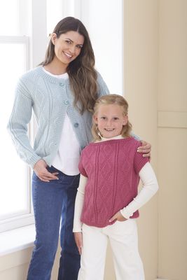 A woman is wearing a light blue knitted cardigan and a girl is wearing a pink knitted top.