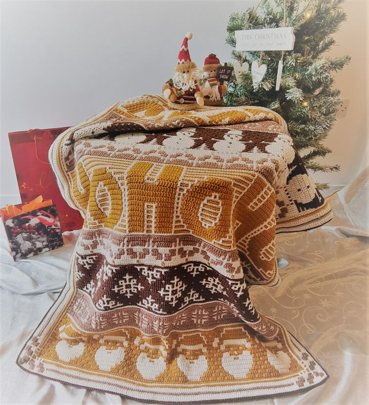 The festive design crocheted blanket in shades of brown and cream.