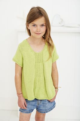 A girl is wearing a light green knitted top.