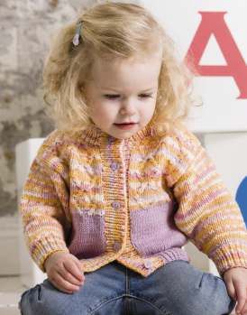 A girl is wearing a knitted cardigan in a variegated orange yarn with pink pockets.