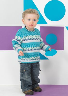 A boy is wearing a knitted sweater in a variegated blue yarn.