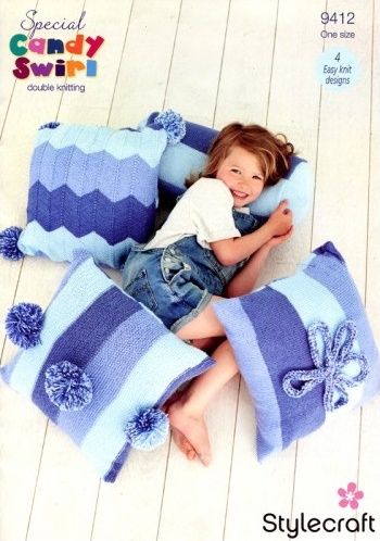 A girl is surrounded by 4 blue stripy knitted cushions.