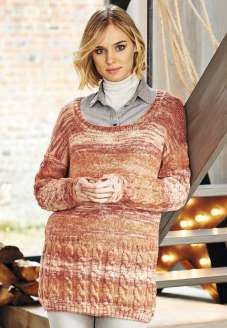 A woman is wearing a knitted sweater in a variegated orange yarn.