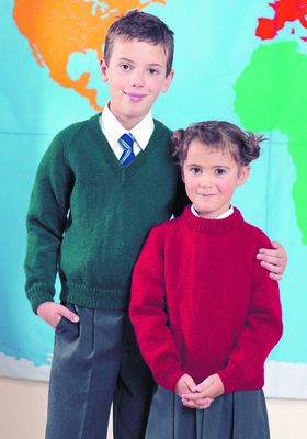 A boy is wearing a dark green knitted sweater, next to a girl wearing a red knitted sweater.