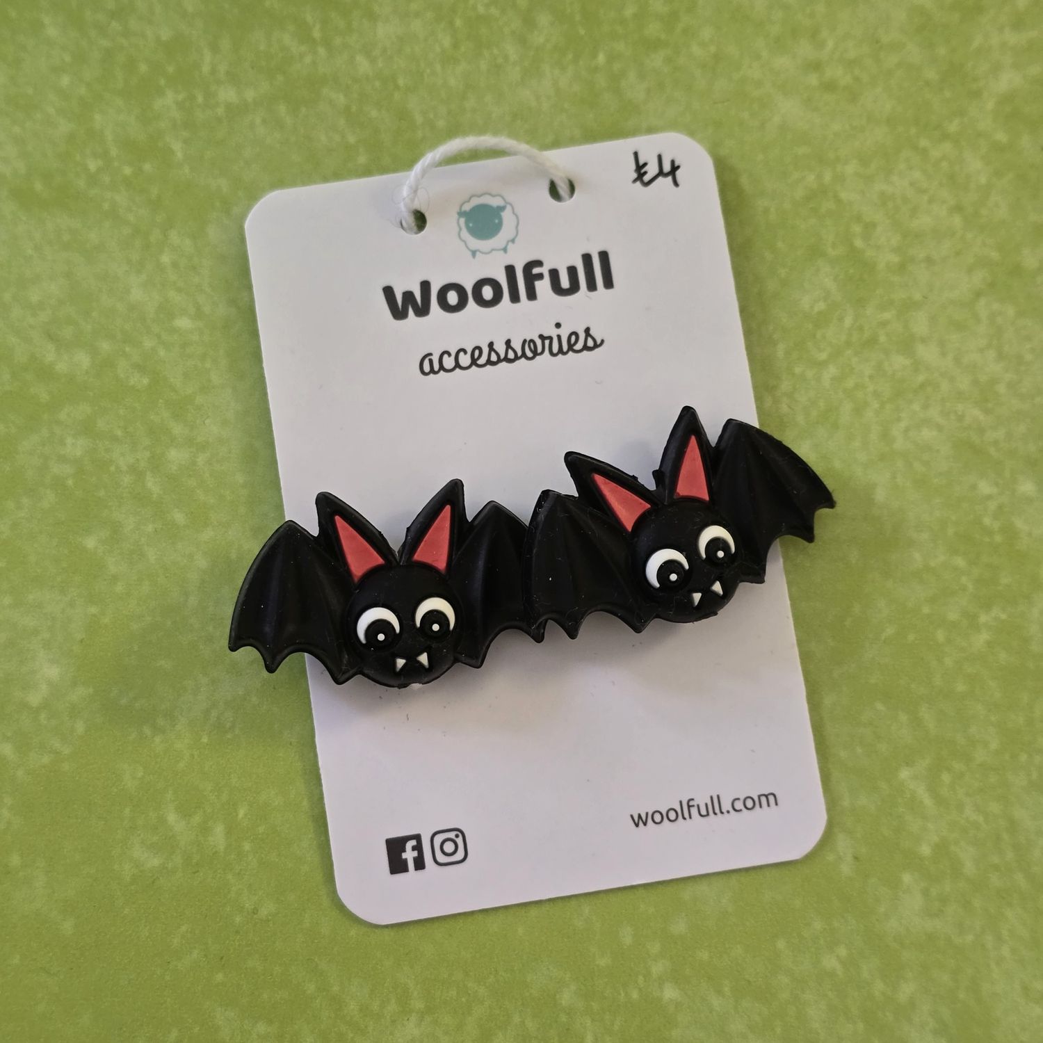 Cartoon bat point protectors mounted on a Woolfull card on a lime green background.