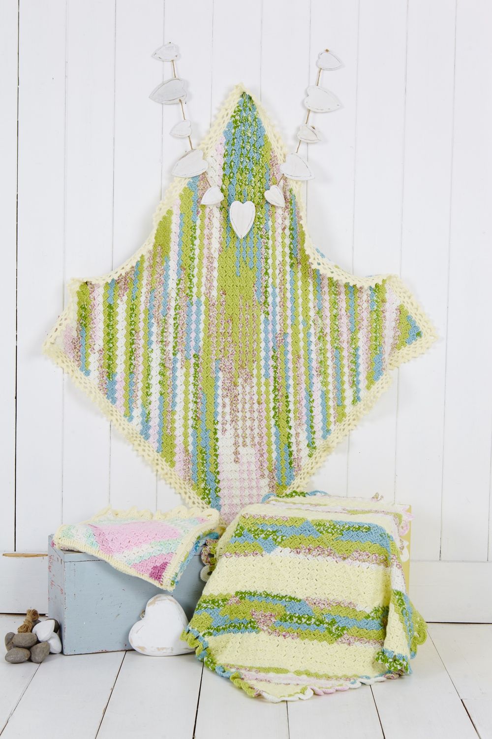 3 crocheted blankets in variegated green, cream, pink and blue.