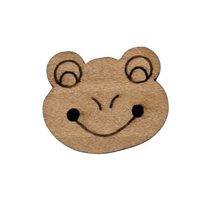 A brown wooden button shaped like a frog&#39;s face.