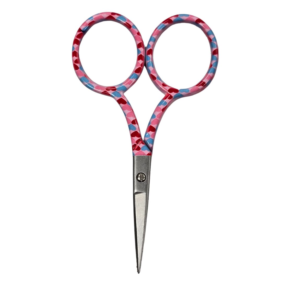 A pair of pink embroidery scissors with pink, red and blue heart print.