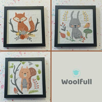 3 cross stitches in black frames. The cross stitch designs are a fox, a rabbit and a squirrel.