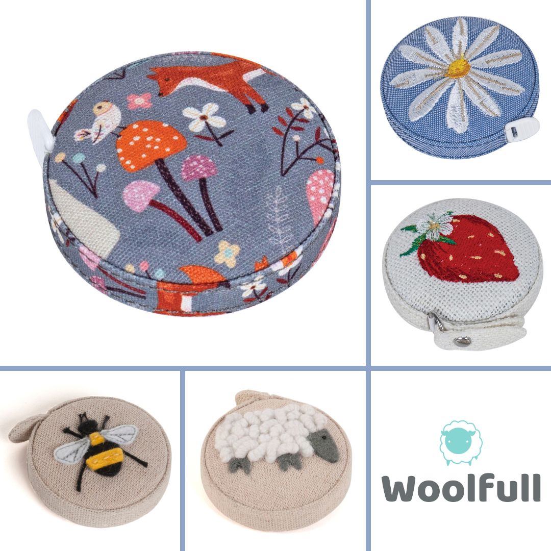 5 fabric covered tape measures, each with an embroidered or appliqued design.