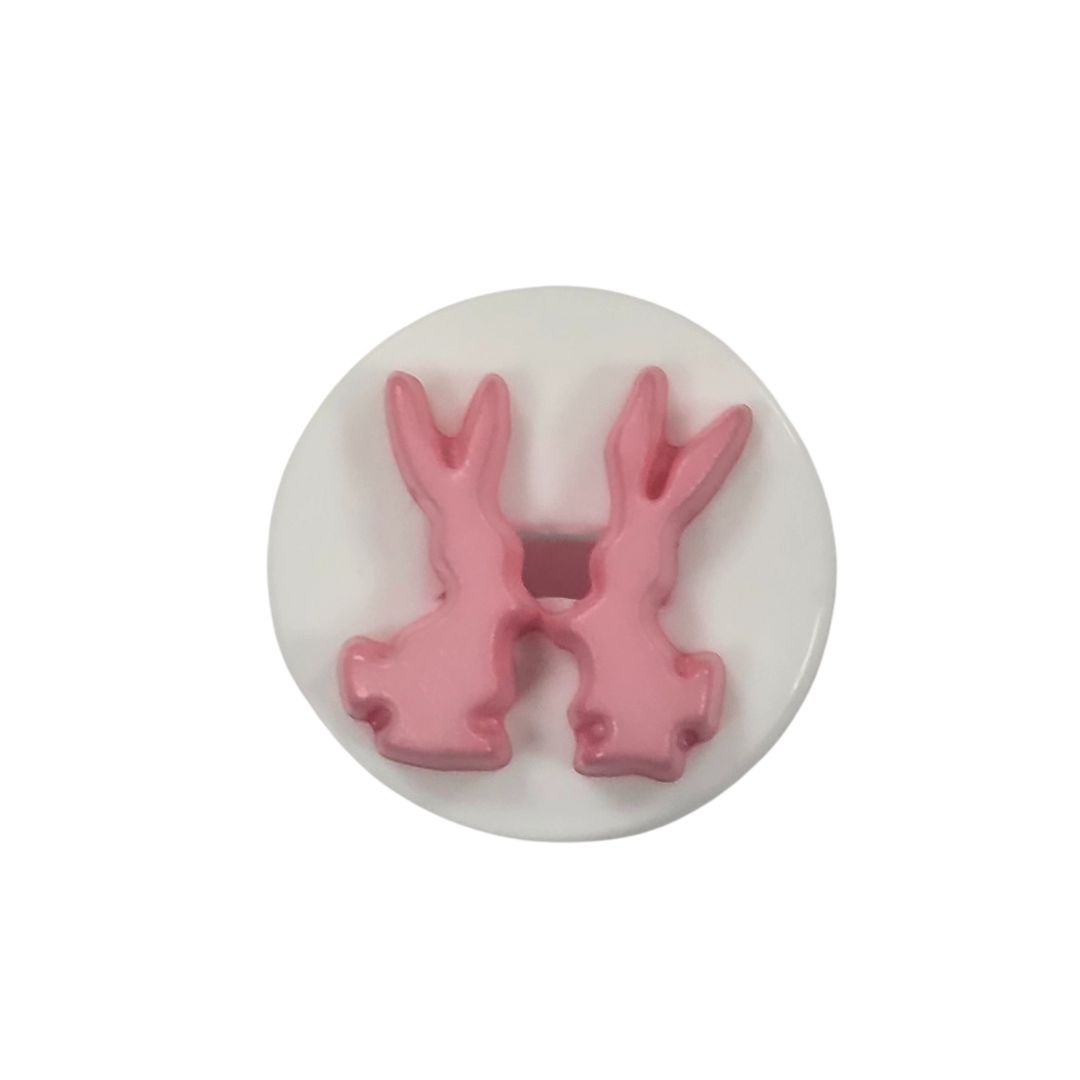 A round white button with 2 pink rabbits.