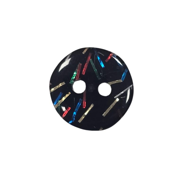 A black button with small red, blue, silver, gold and green pieces inside.