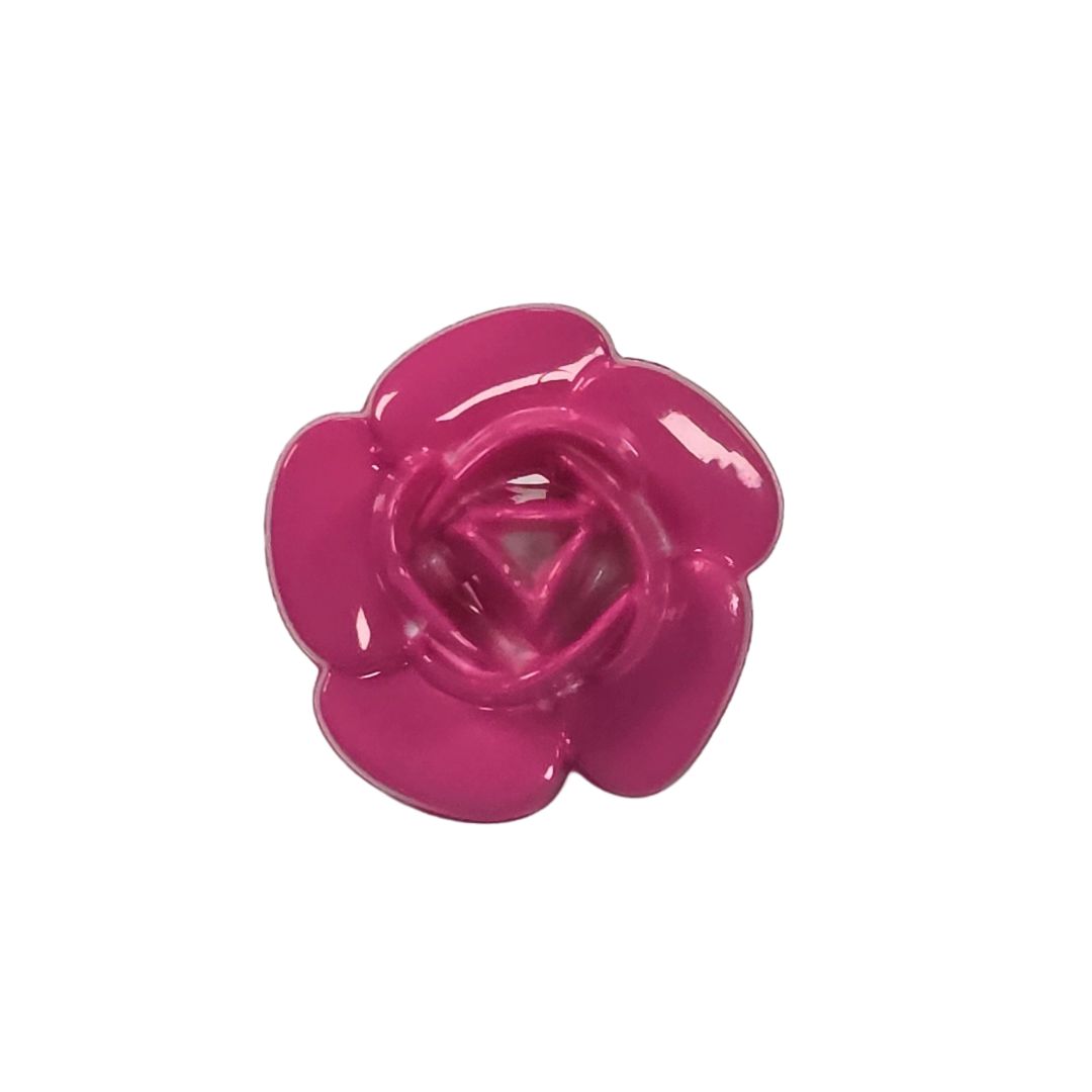 A bright pink rose shaped button.