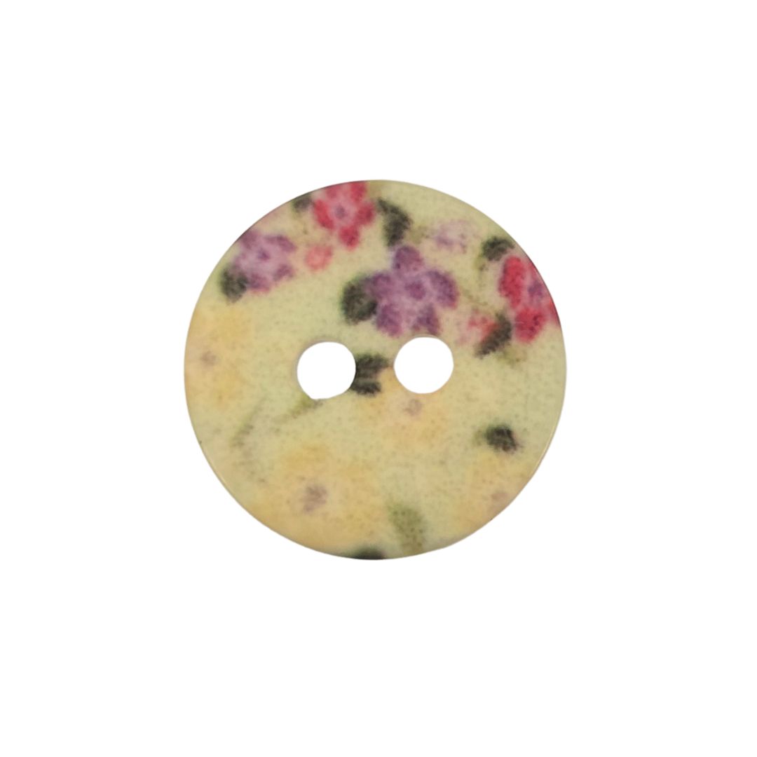 A round cream button with a floral print.