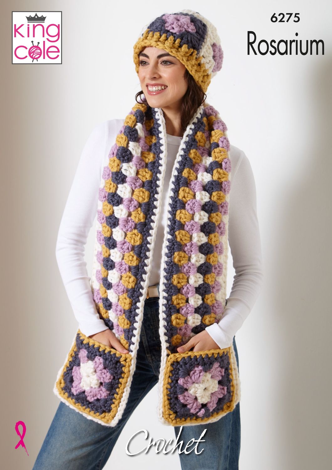 A woman is wearing a cream, grey, lilac and mustard crocheted scarf and matching hat.