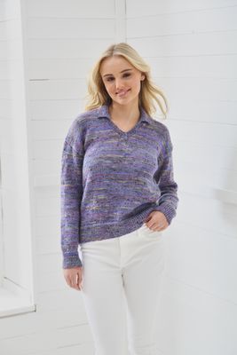 A woman is wearing a variegated purple knitted sweater.