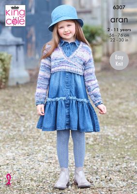 A girl is wearing a knitted ballet cardigan in a variegated blue and purple yarn.