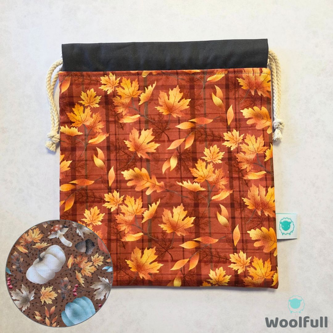 A project bag in a brown fabric with an oak leaf print, with a swatch of the brown pumpkin and leaf print lining.