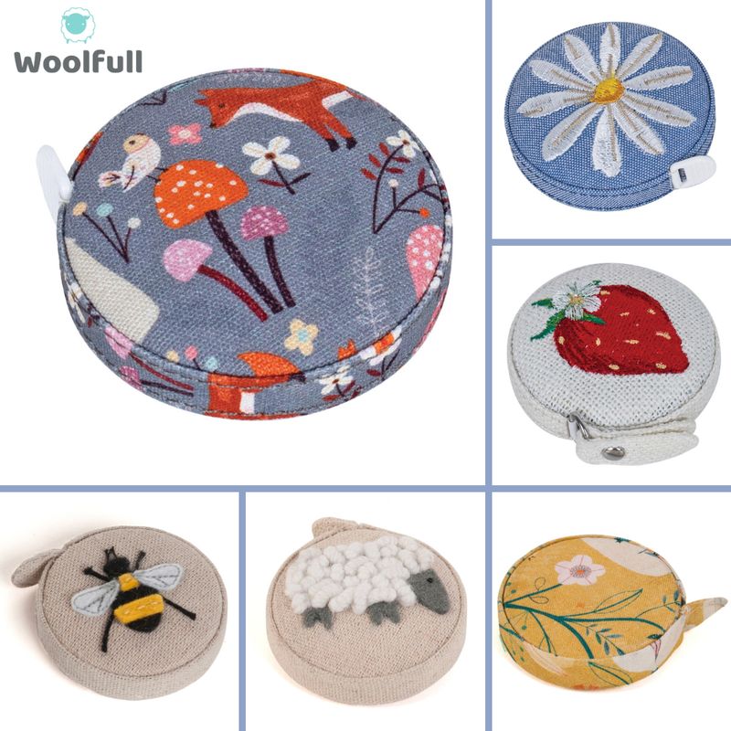 6 fabric covered tape measures, each with a printed or embroidered design.