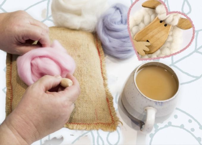 A person needle felting with pink wool roving.