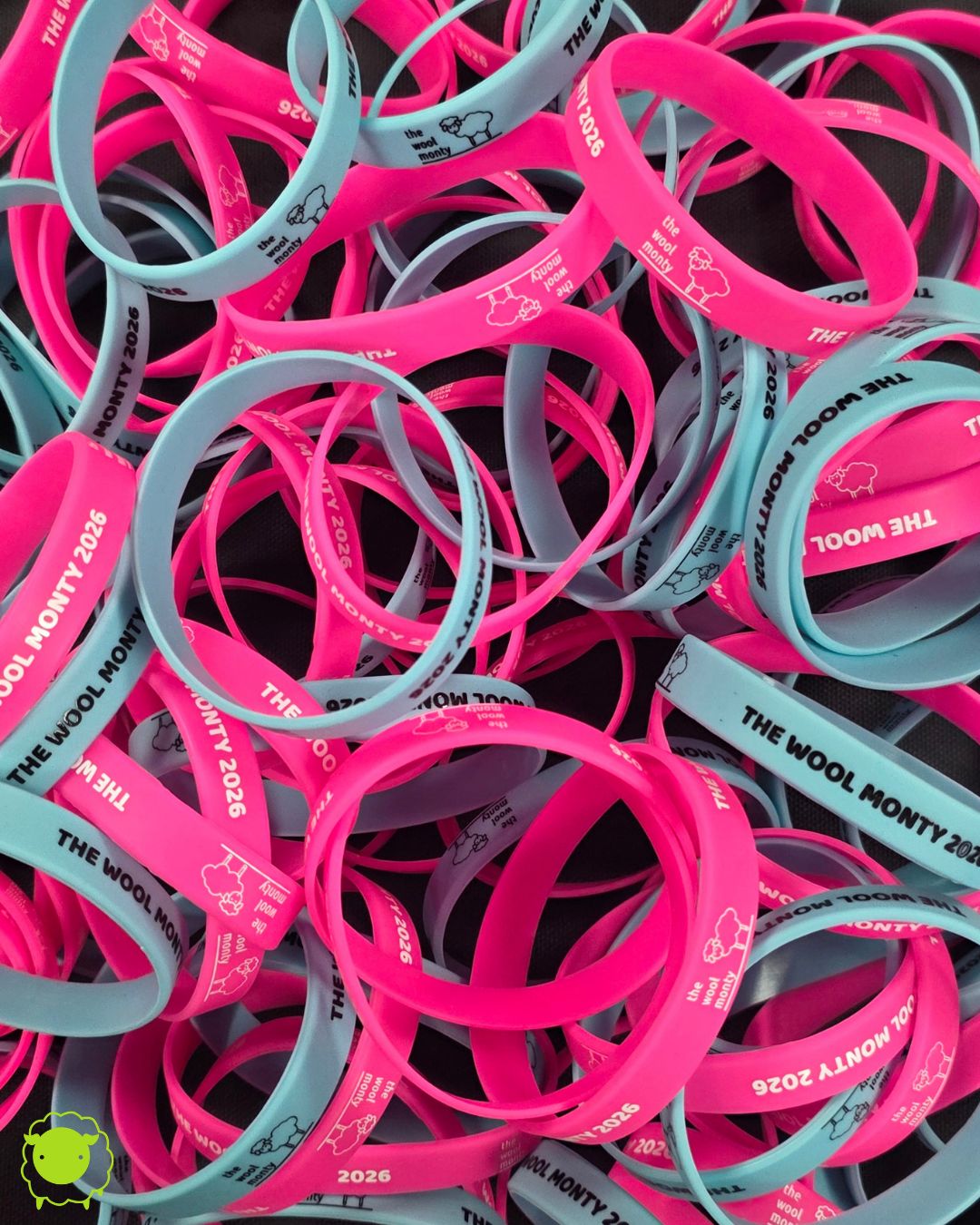 A pile of silicone wristbands, some pink and some blue.