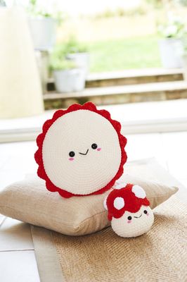 A crocheted toadstool toy and matching cushion.