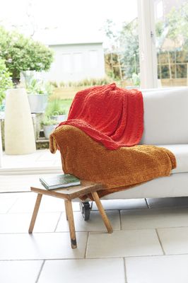 2 knitted blankets, 1 red and 1 brown.