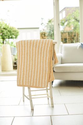 A cream and beige knitted blanket.