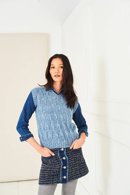 A woman is wearing a light blue knitted tank top.