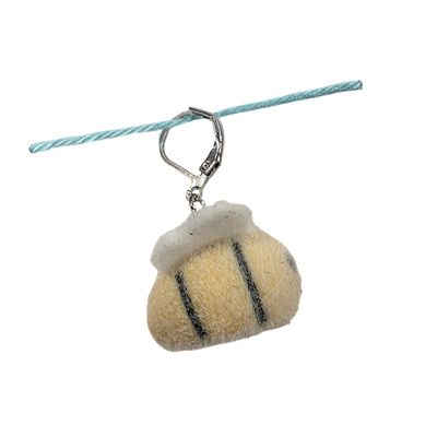 A fuzzy yellow, black and white bee shaped stitch marker.