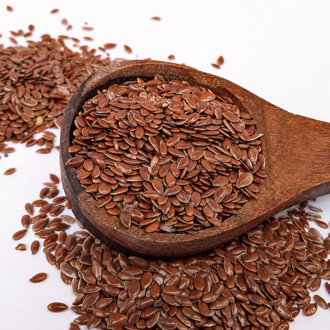 Organic flax seeds (alsi) with glossy brown shells, naturally rich in plant-based omega-3s and fibre for everyday wellness.