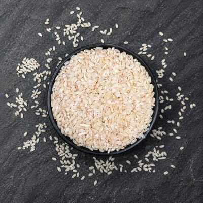 Organic Heritage Red Choba Rice in a bowl, showcasing naturally varied grains with a distinctive reddish hue and appeal.
