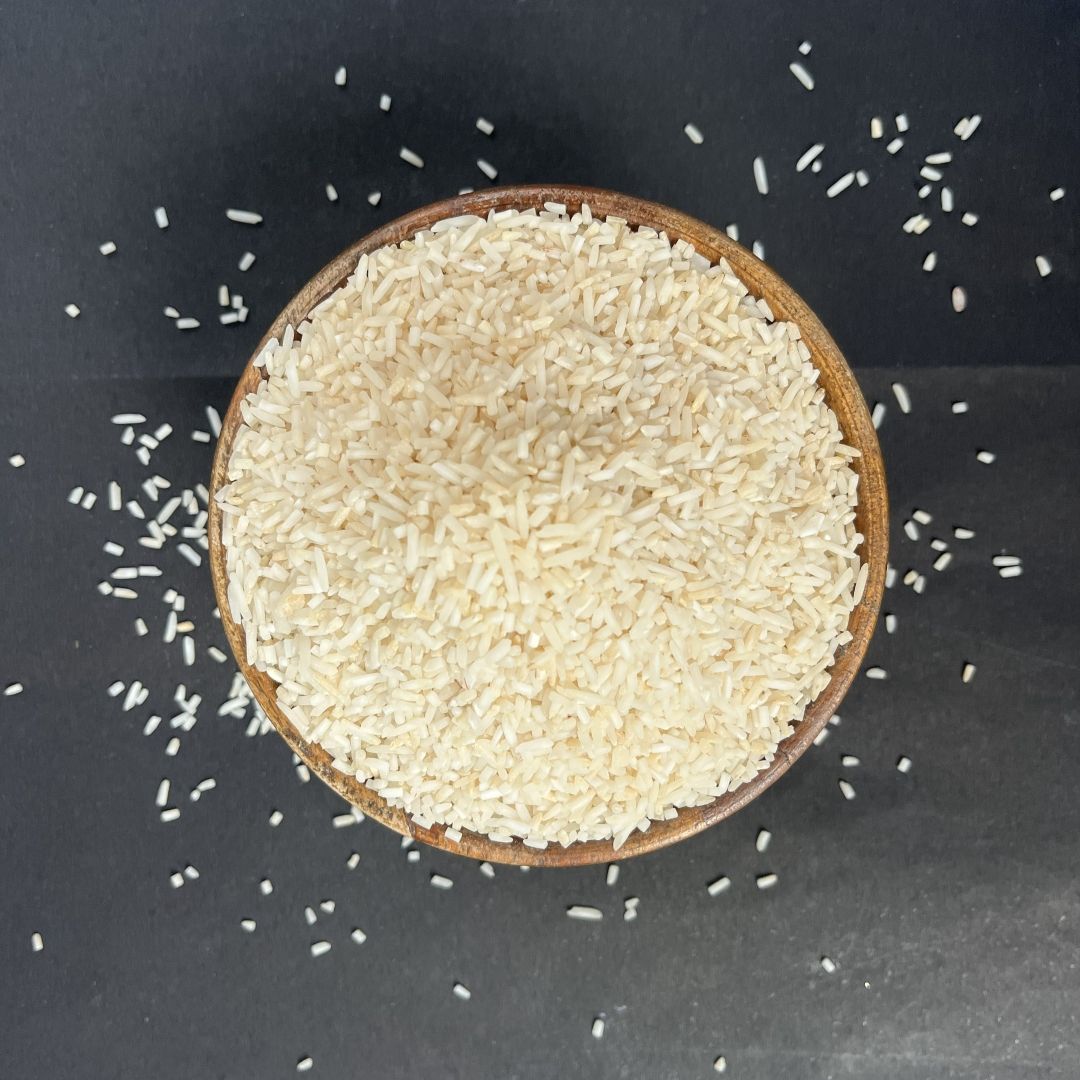 Organic Tukda Basmati Rice in a wooden bowl, showcasing distinct broken rice pieces with a clean, natural appearance.