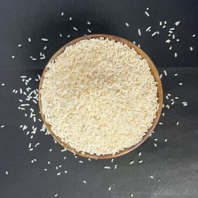 Organic Tukda Basmati Rice in a wooden bowl, showcasing distinct broken rice pieces with a clean, natural appearance.