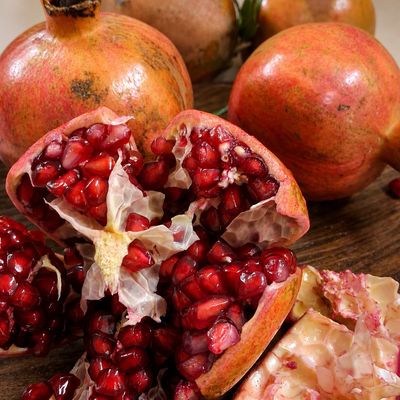Organic Anaar Pomegranate with ruby-red juicy arils, highlighting its fresh texture and vibrant natural colour.
