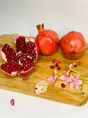 Organic Anaar Pomegranate with ruby-red juicy arils, highlighting its fresh texture and vibrant natural colour.