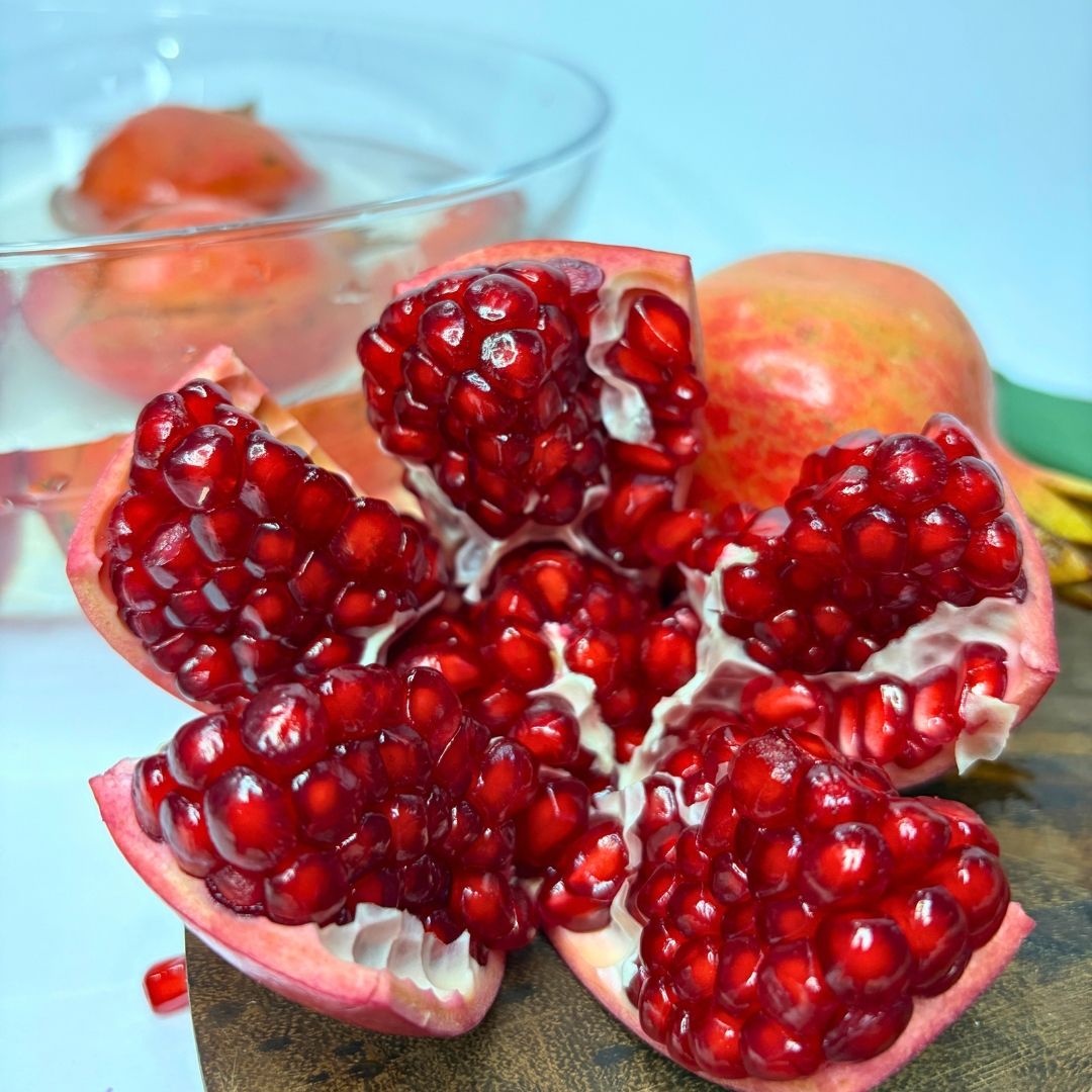 Organic Anaar Pomegranate with ruby-red juicy arils, highlighting its fresh texture and vibrant natural colour.